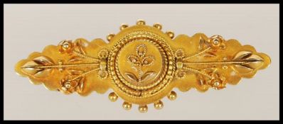 A 19th Century Victorian mourning brooch stamped 15ct having applied ball and wirework, forming