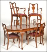 A 20th Century extendable walnut Queen Anne revival dining table of oval form raised on Queen Anne