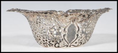 A Canadian sterling silver bonbon dish having embossed scroll and foliate decoration with pierced
