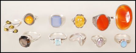 A selection of silver ladies dress rings to include a ring set with a round cut brown stone, two
