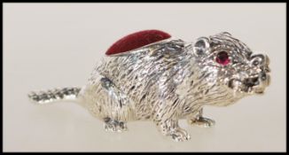 A stamped 925 silver pincushion in the from of a beaver having a red velvet pincushion to the back