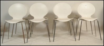 A set of Galvano Tecnica Italian white plastic formed shell dining stacking chairs having a shell