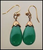 A pair of 20th century vintage ladies drop earrings set with polished teardrop green jade style