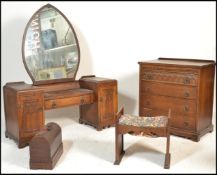 A believed Woods Bros mid century oak Jacobean revival dressing table, stool and chest of drawers.
