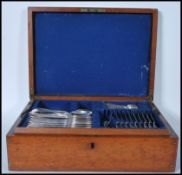 A Victorian 19th century oak cased canteen of cutlery having campaign style handles. The contents