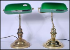 Two vintage 20th Century banker's desk lamps both raised on stepped round plinth bases, with