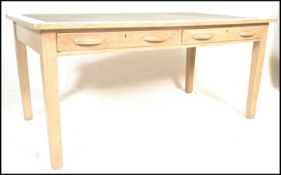 A mid 20th Century school / air ministry desk,constructed from beech wood, flared top with inset