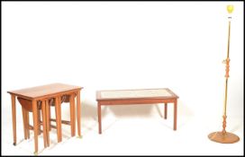 A retro teak wood nest of tables of rectangular form with multiple tables hanging to the underside