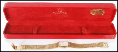 A gold plated Omega De Ville ladies cocktail wrist watch having quartz movement. The face of the