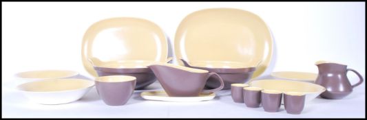 A vintage 20th Century part dinner service by Poole Pottery. The two tone colour service