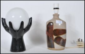 Two vintage mid 20th Century table lamps / lights to include a black glass lamp in the form of two