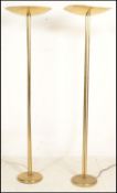 A pair of 20th Century Art Deco style standard floor lamp uplighters. Raised on a circular gilt base