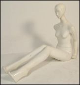 A vintage 20th Century shop display female mannequin having metamorphic posable limbs, with original