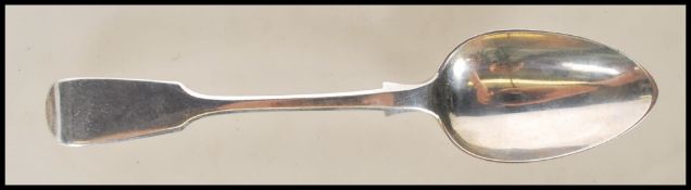 An English hallmarked Victorian silver spoon in the fiddle pattern, hallmarked London 1860, makers