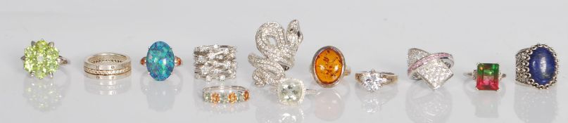A group of twelve silver rings of various designs to include single solitaire white stone ring,
