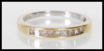An English hallmarked 18ct gold ring channel set with square cut diamonds. Assay marked for