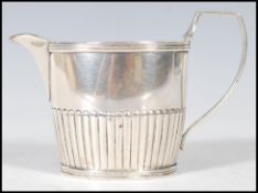 A late 19th Century silver hallmarked creamer / milk jug of small proportions having gadrooned
