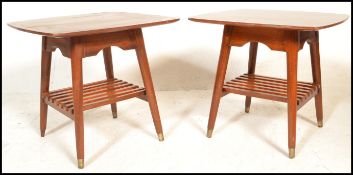 A pair of vintage 20th century 1970's coffee tables having square table tops with splayed tapering