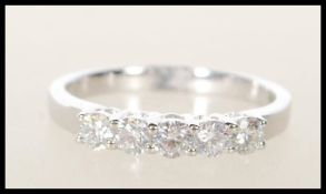 A hallmarked 18ct white gold five stone diamond ring of approx 35pts. Hallmarked 750 London. Ring