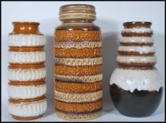 A group of three retro 20th Century West German fat lava vases / stick stands of various heights,