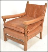 A good early 20th century leather upholstered easy armchair. The show wood frame raised on squared