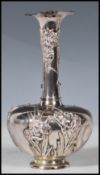 A Chinese silver vase of small proportions having a bulbous body with tapering trumpet neck