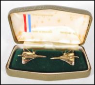 A pair of gold tone gentleman's cufflinks in the from of Concorde displayed in their original