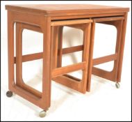 A vintage mid 20th Century McIntosh teak wood nest of tables with folding occasional top and 2 small