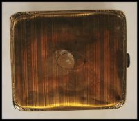 A mid 20th Century gilt silver vesta case having an engine turned decoration with an oval panel to