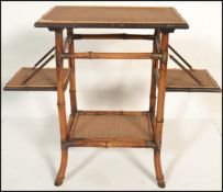 A 19th Century Victorian Aesthetic movement bamboo two tier occasional side table having rattan