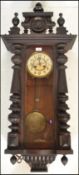 A 19th Century Vienna regulator pendulum wall clock being mahogany cased with turned knopped columns
