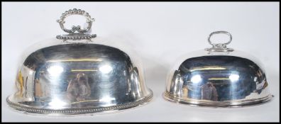 A large early 20th century silver plated meat dome cover with handle atop together with a smaller