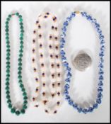 A group of three 20th Century beaded necklaces to include a malachite beaded necklace, a white glass