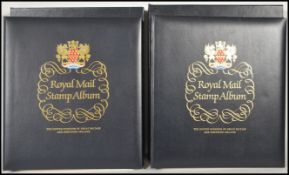 Royal Mail Luxury GB Queen Elizabeth hingeless stamp albums (2) in slip-in cases.Vol 1 1953-1970,
