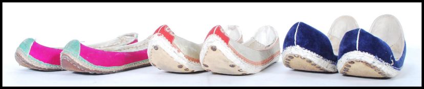 A selection of early 20th Century Chinese traditional manchu style slip on shoes having riveted flat