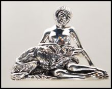 A stamped sterling silver brooch pendant in the manor of Georg Jensen depicting a nude lady
