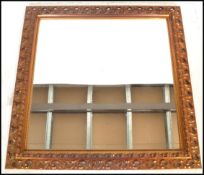 A 20th century giltwood and gesso framed rectangular overmantle wall mirror of square form,