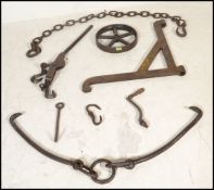 A collection of cast iron industrial farming items