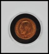 A 1911 George V full 22ct gold sovereign coin, King George V to front with George slaying the dragon