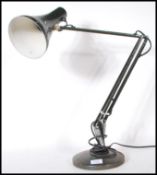 A vintage 20th Century Herbert Terry anglepoise desk lamp having a pendant shade on an adjustable