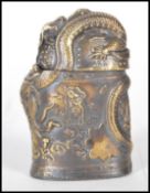 A brass vesta case having embossed Chinese dragon decoration amongst the clouds also depicting a