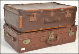 Two vintage 20th Century suitcase trunks to include a brown leather trunk painted with initials W.
