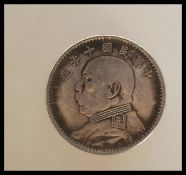 A Republic of China year 10 silver dollar having Yuan Shikai facing left. Weight 27.5g. Measures 4cm