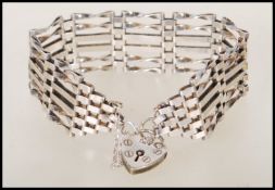 A hallmarked 925 6 bar gate link bracelet having a heart lock clasp. Hallmarked London. Weight 19.