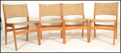 A set of four mid 20th century 1960's Danish dining chairs having teak frames with pad upholstered