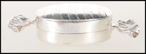A stamped 925 silver pill box in the form of sweetie. Weighs 14.2g. Measures 1.5cm tall by 5.5cm