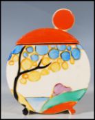 A early 20th Century Art Deco ceramic lidded sugar dish, hand painted with cottages to one side