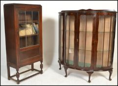 A 1930's mahogany Queen Anne revival bow fronted china display cabinet with twin opening doors