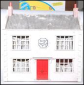 A vintage 20th Century 1930's style wooden constructed dolls house, twin chimneys to the tiled