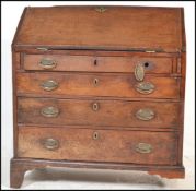 A Georgian 19th century mahogany bureau desk. Raised on bracket feet with a bank of drawers having